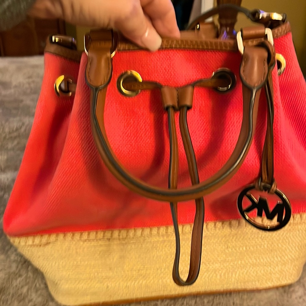 Michael Kors Canvas bag with straw colored base. The shoulder strap is 20-1/2” L